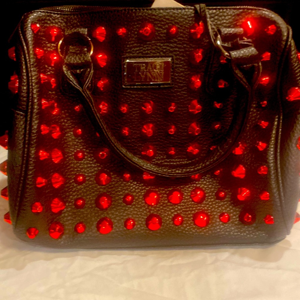 Traci Lynn Handbag, in good condition, Black with red studs